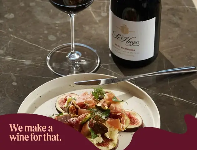 a plate of food and a bottle of wine