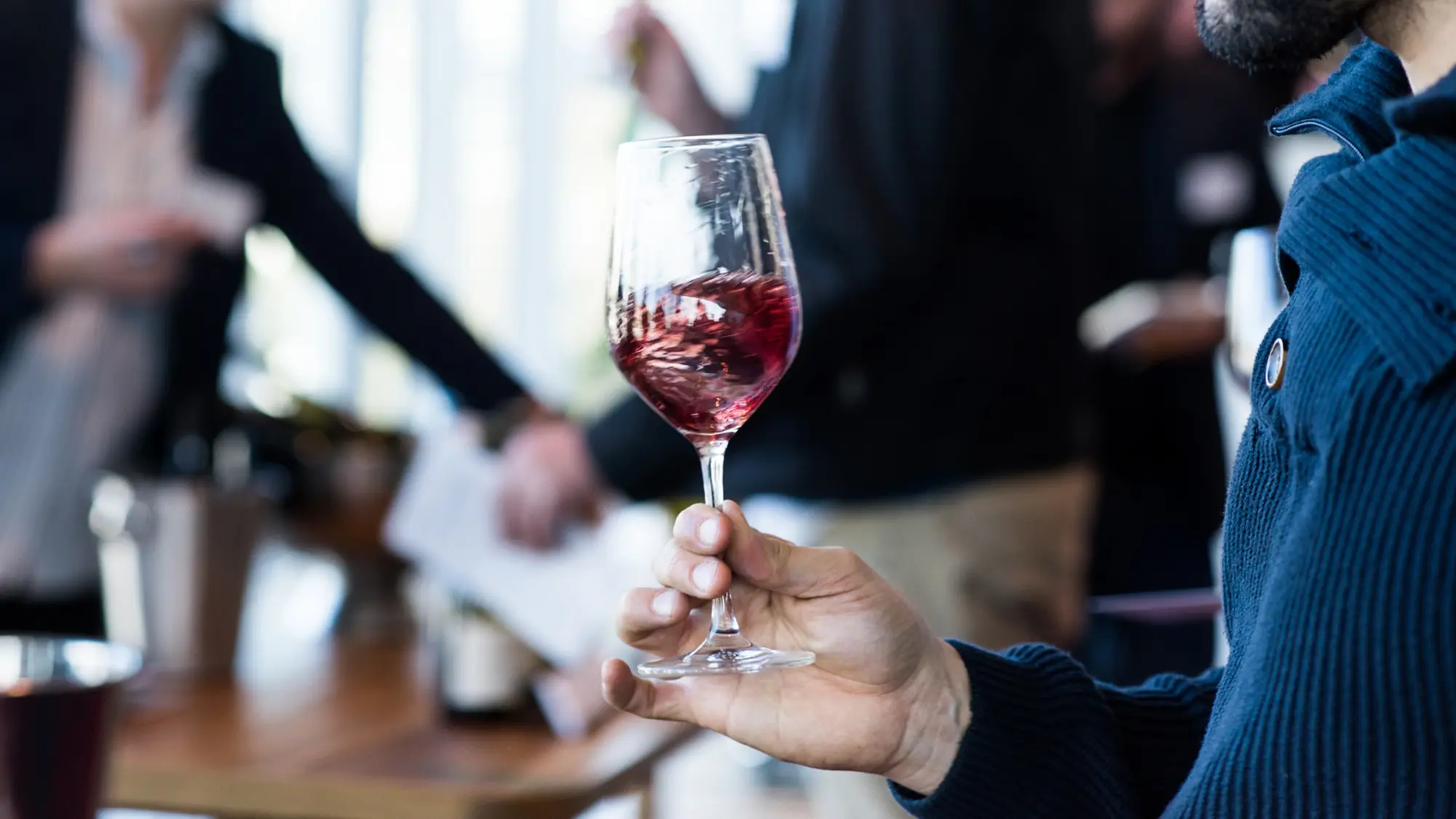 a hand holding a wine glass