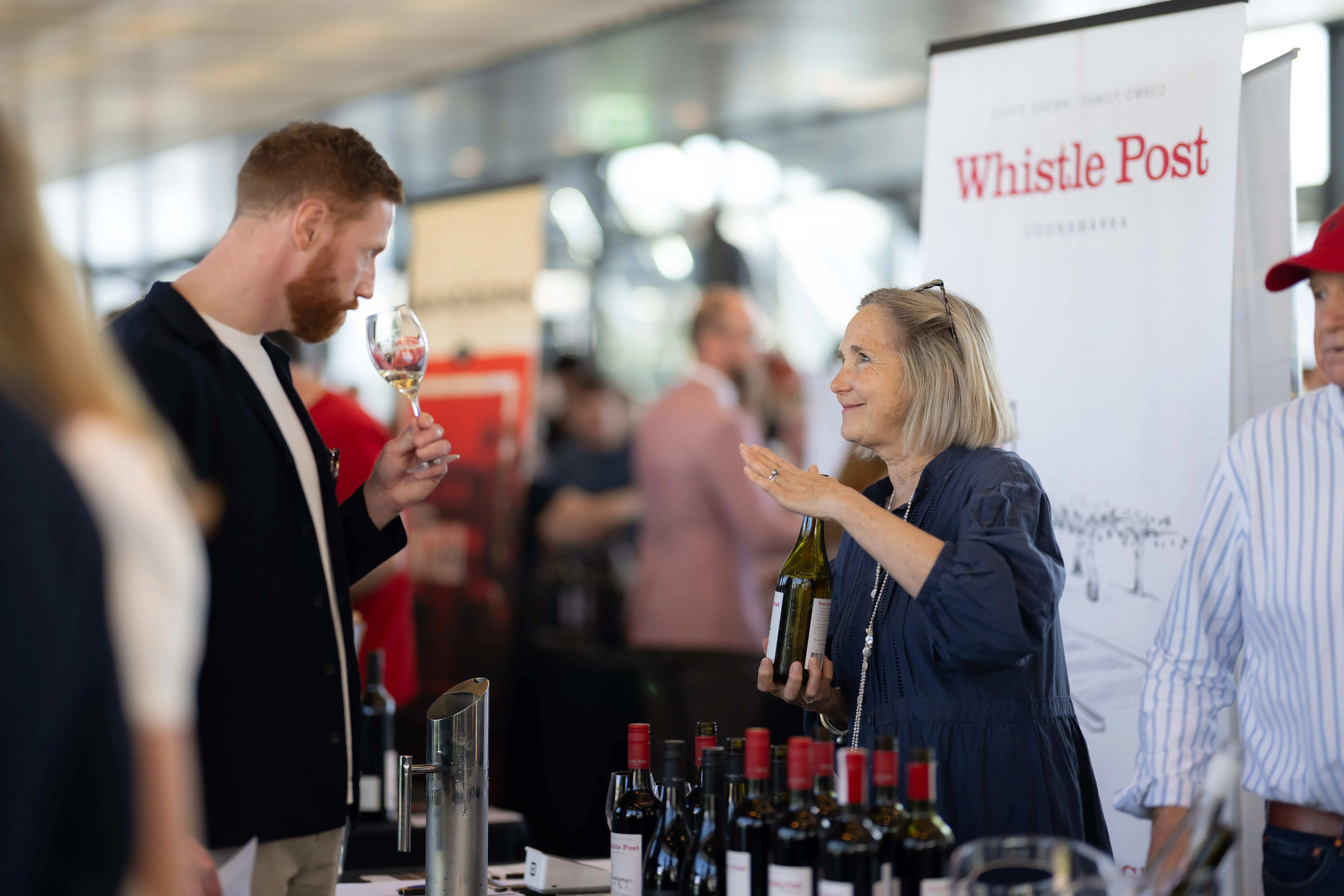 a man and woman at a wine tasting event
