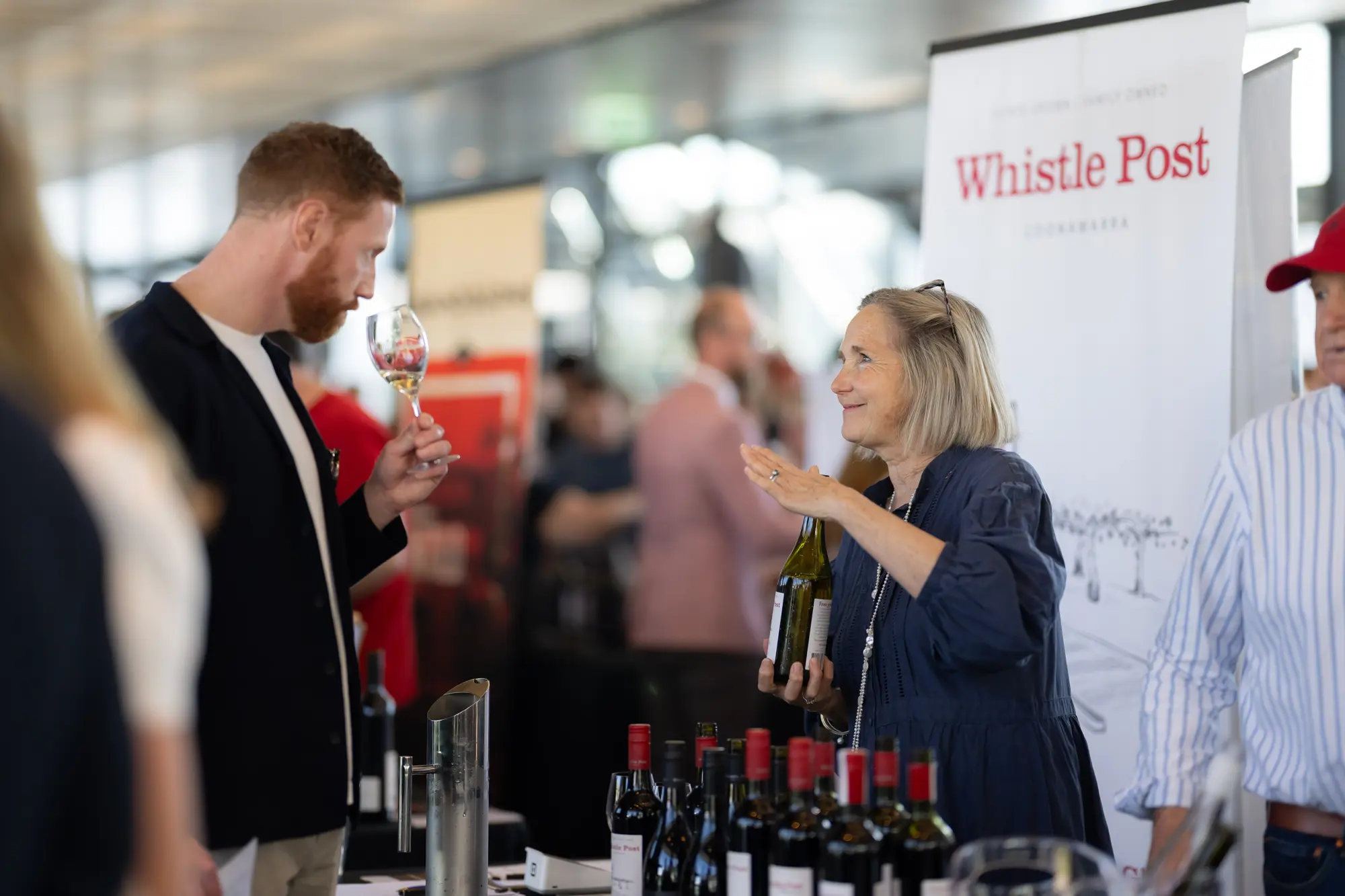a man and woman at a wine tasting event