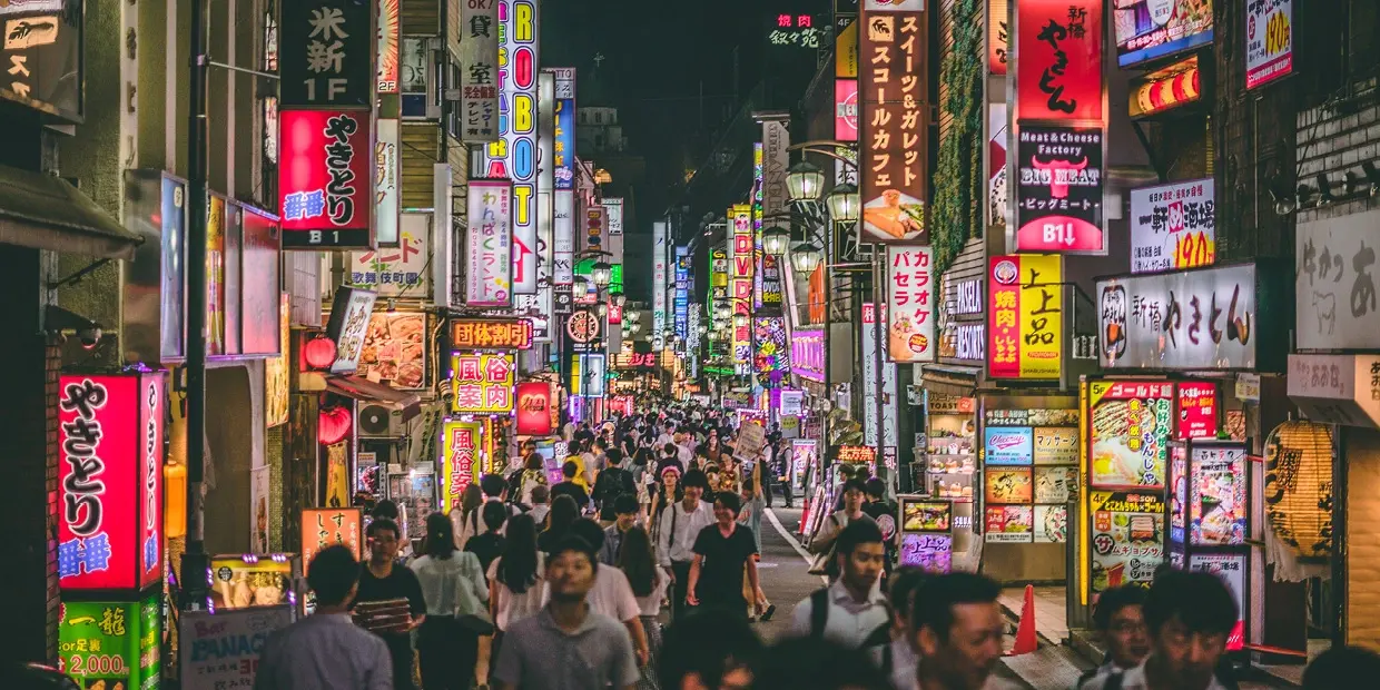 a crowd of people walking in Kabukichō, Tokyo