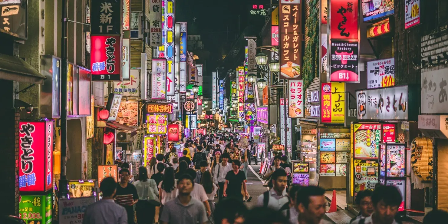 a crowd of people walking in Kabukichō, Tokyo