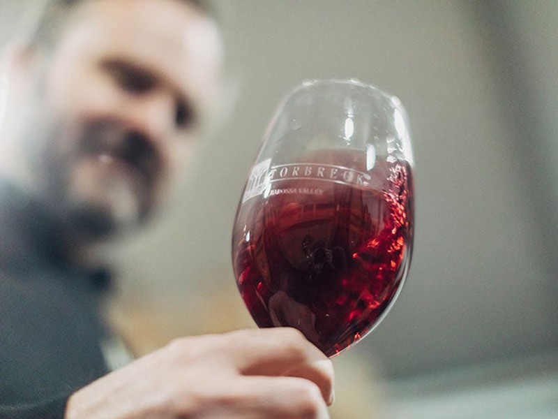 Ian Hongell swirling red wine in glass