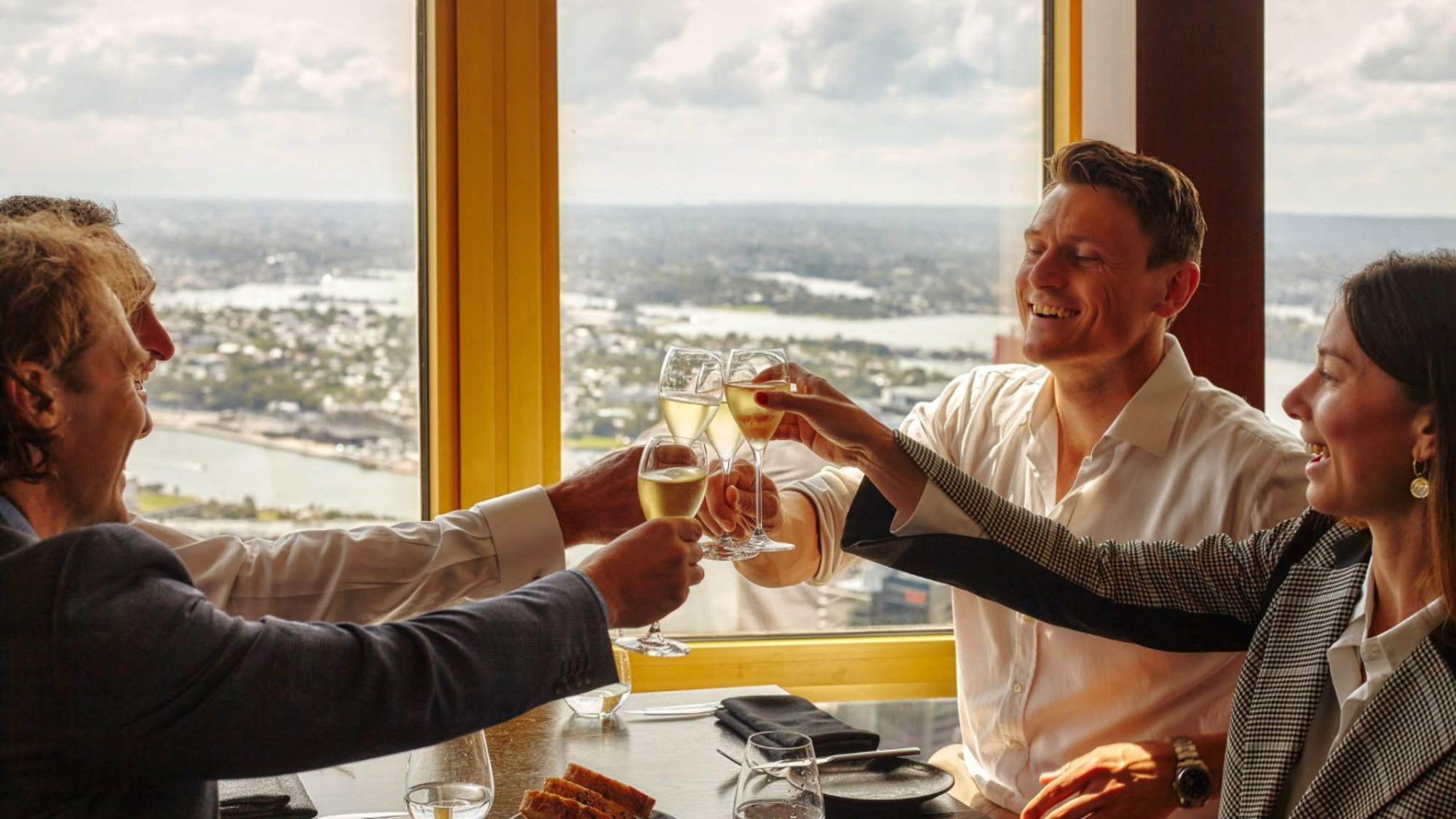 a group of people clinking glasses of wine