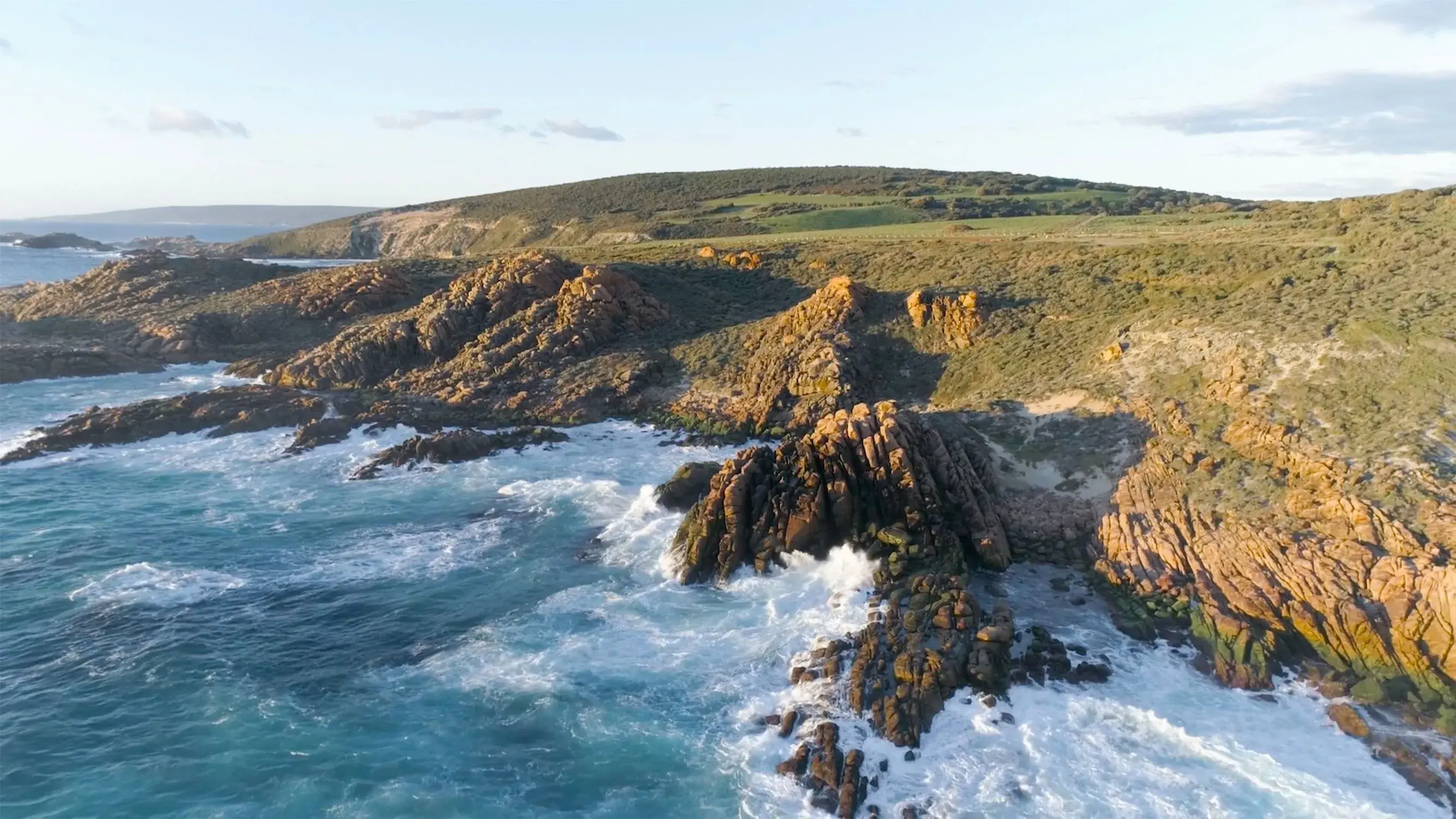 a rocky coastline with waves crashing on the rocks