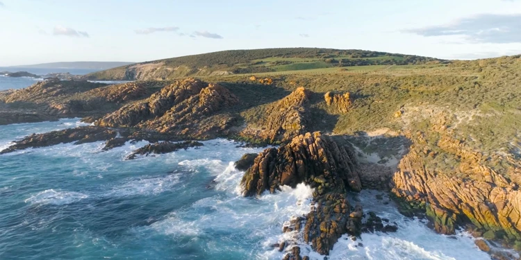 a rocky coastline with waves crashing on the rocks