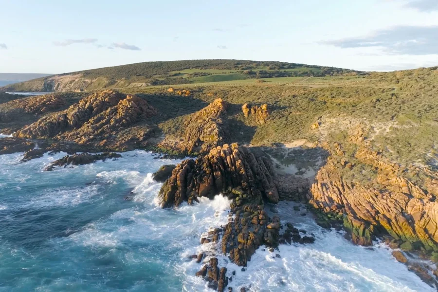 a rocky coastline with waves crashing on the rocks