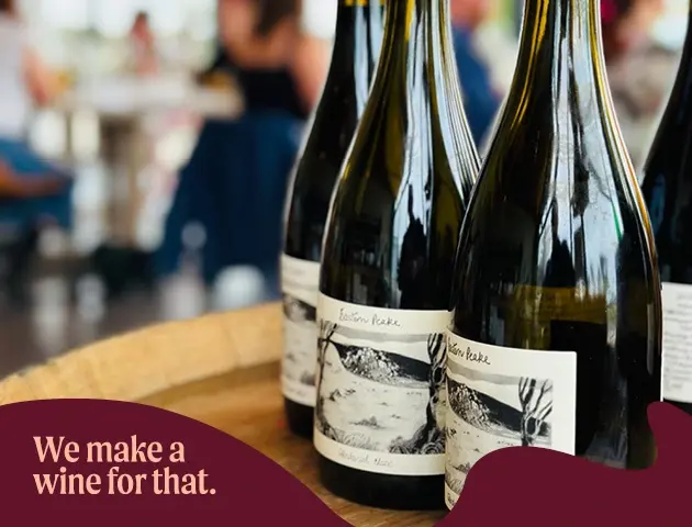 a group of wine bottles on a barrel