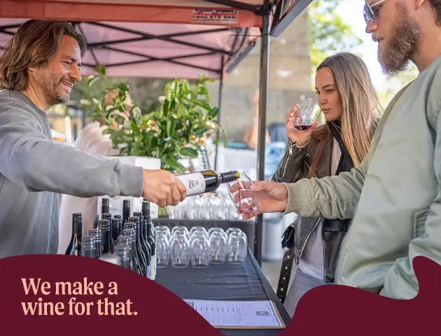 a man pouring wine into a bottle