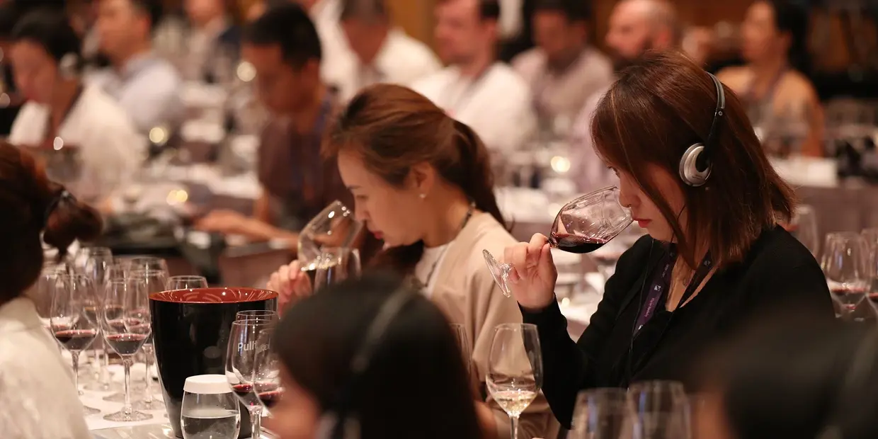 a group of people drinking wine