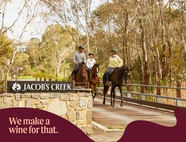 a group of people riding horses on a bridge