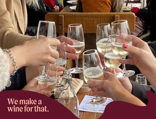 a group of people holding wine glasses