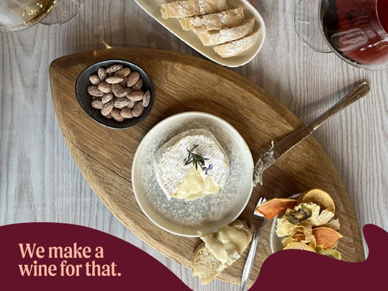 a plate of cheese and snacks on a wooden tray
