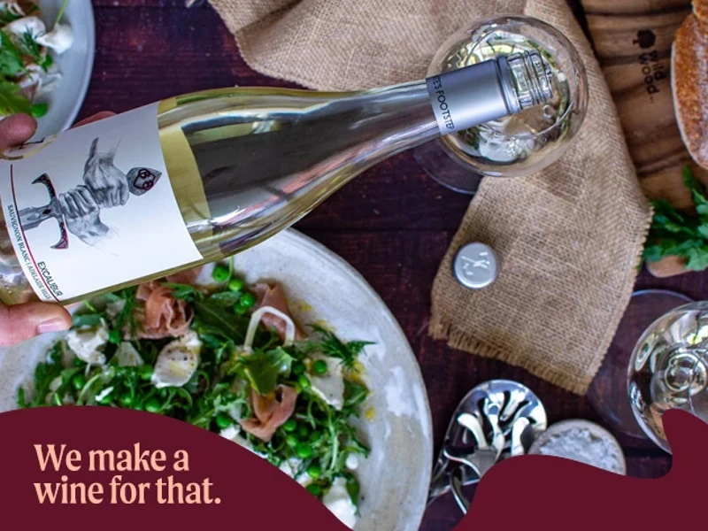 a bottle of wine on a plate of food