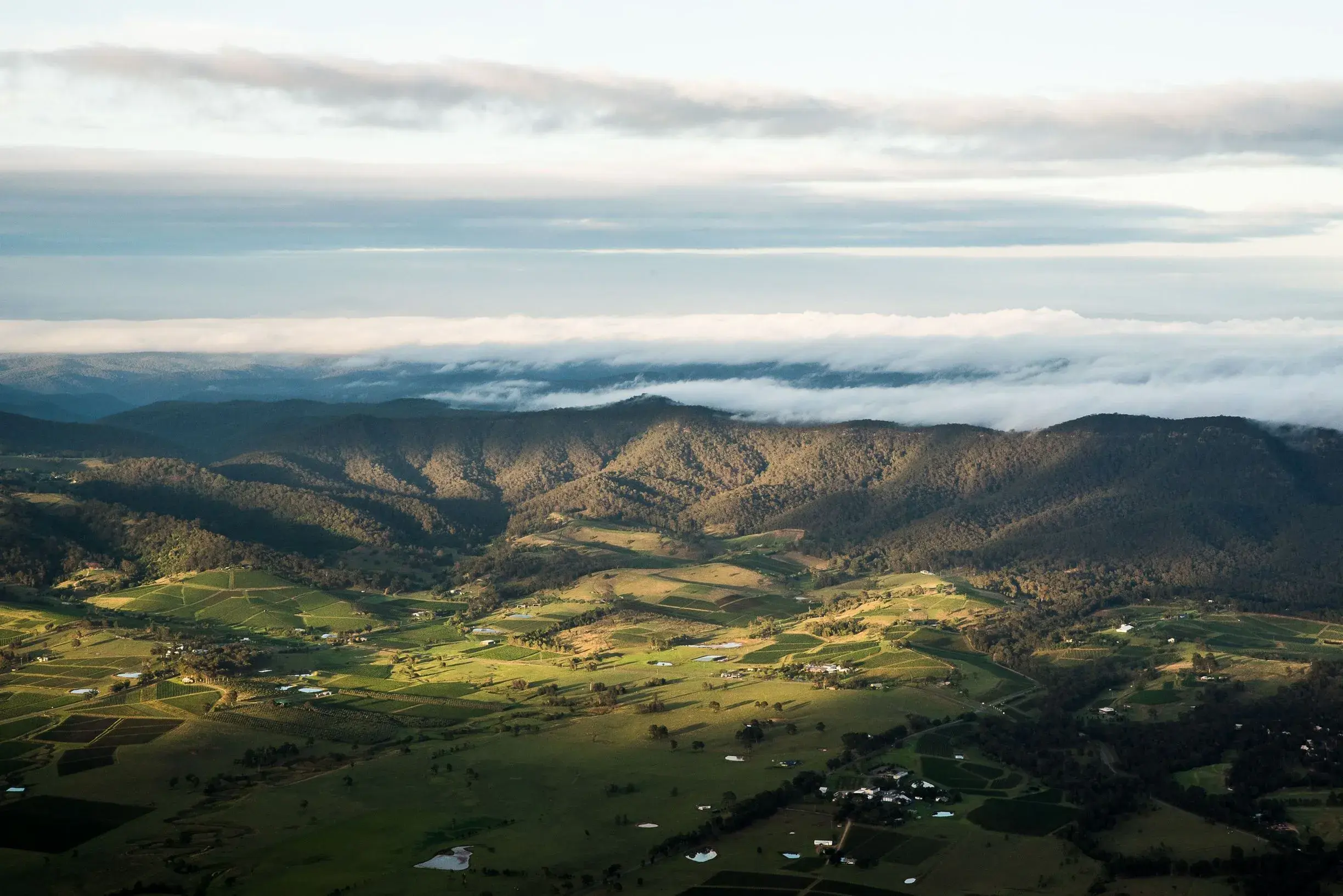 a landscape with clouds and mountains