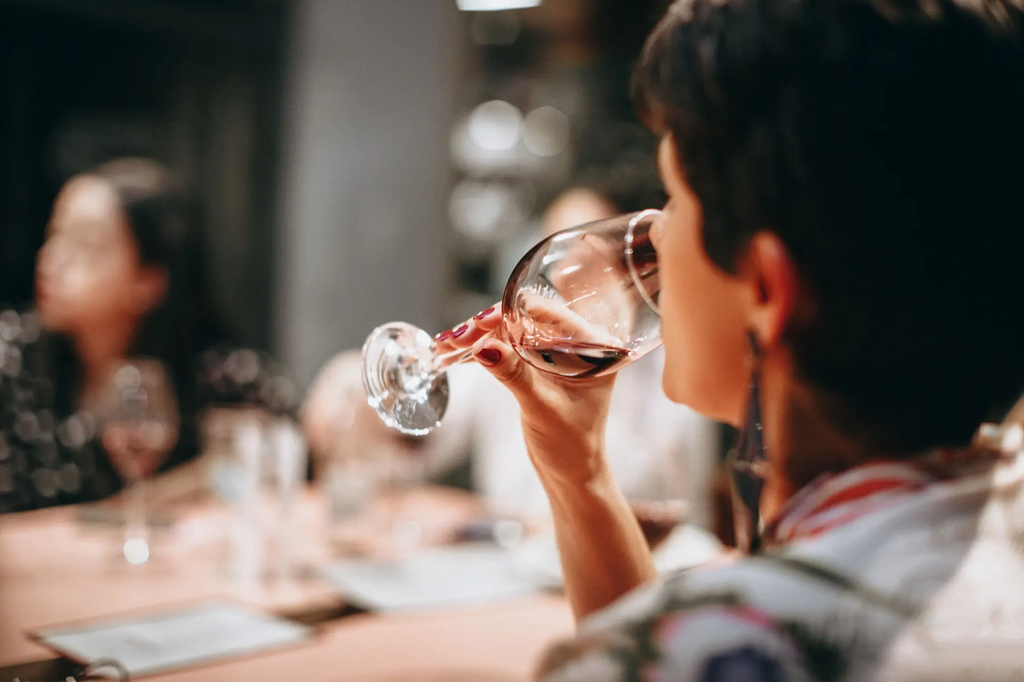 a woman drinking from a wine glass