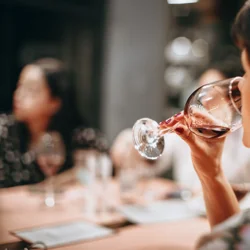 a woman drinking from a wine glass