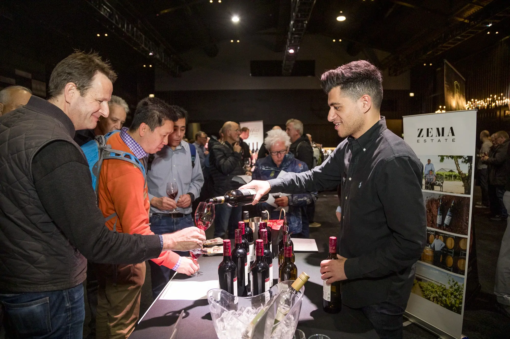 a man pouring wine into a glass