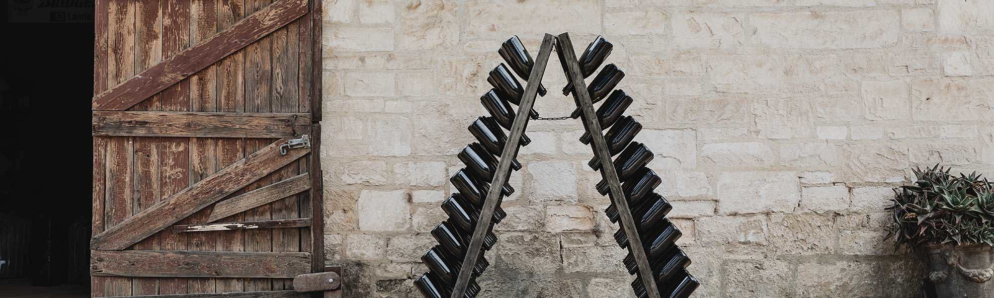 Riddling rack with sparkling wine outside brick warehouse