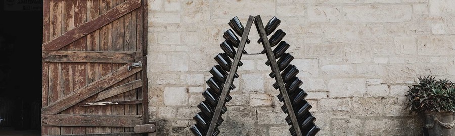 Riddling rack with sparkling wine outside brick warehouse