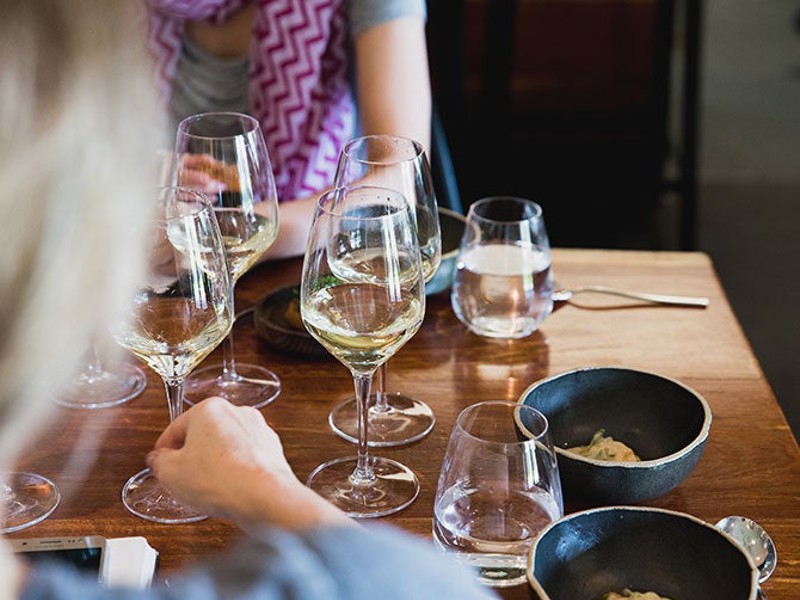 People drinking white wine with food