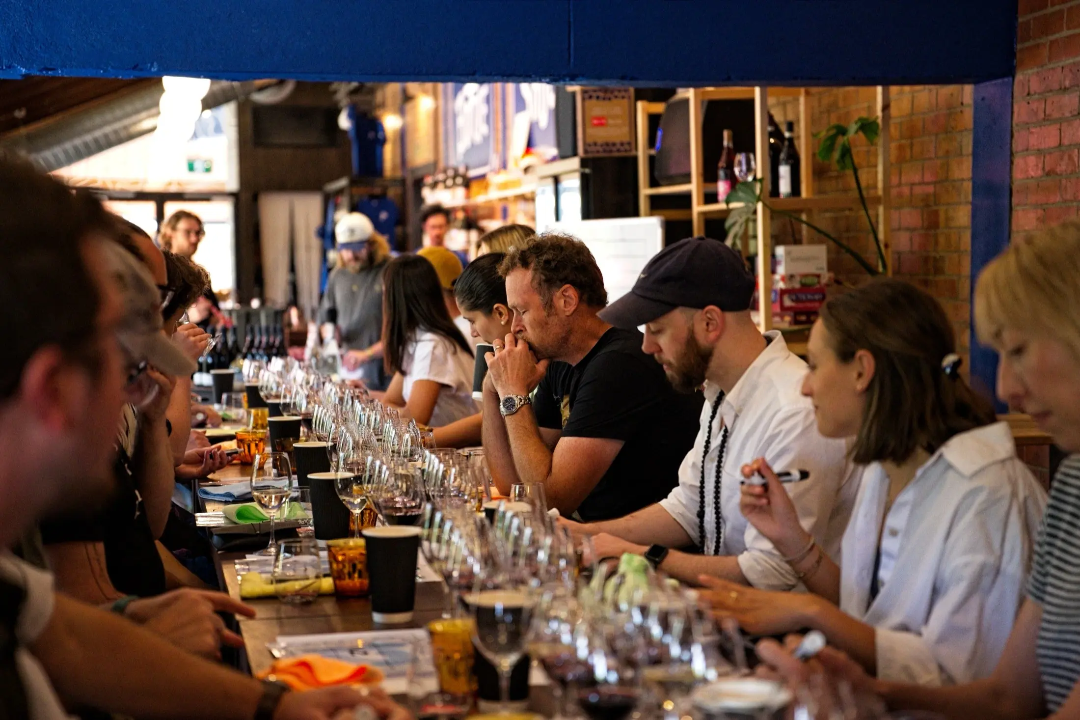 a group of people sitting at a table with glasses of wine