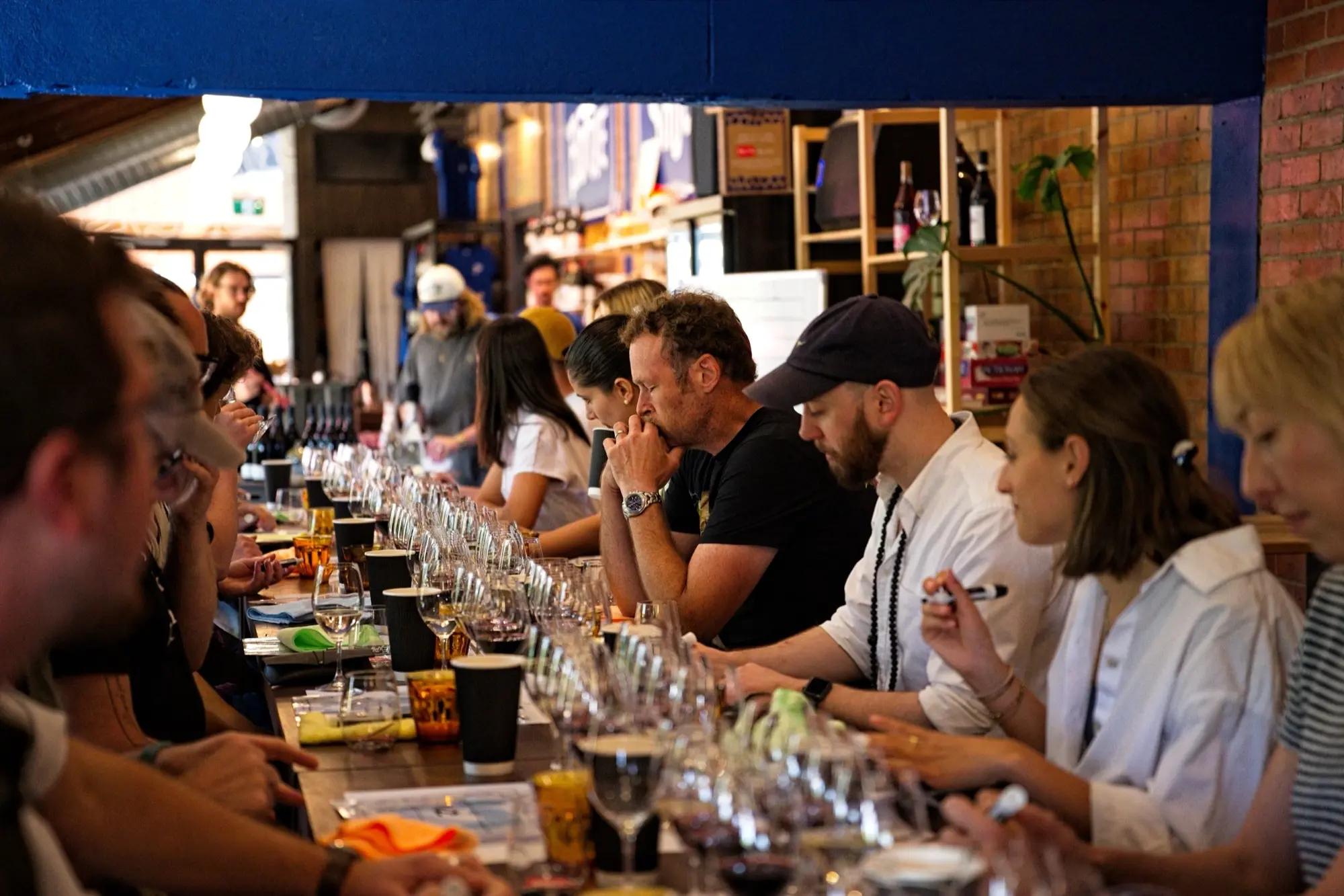 a group of people sitting at a table with glasses of wine