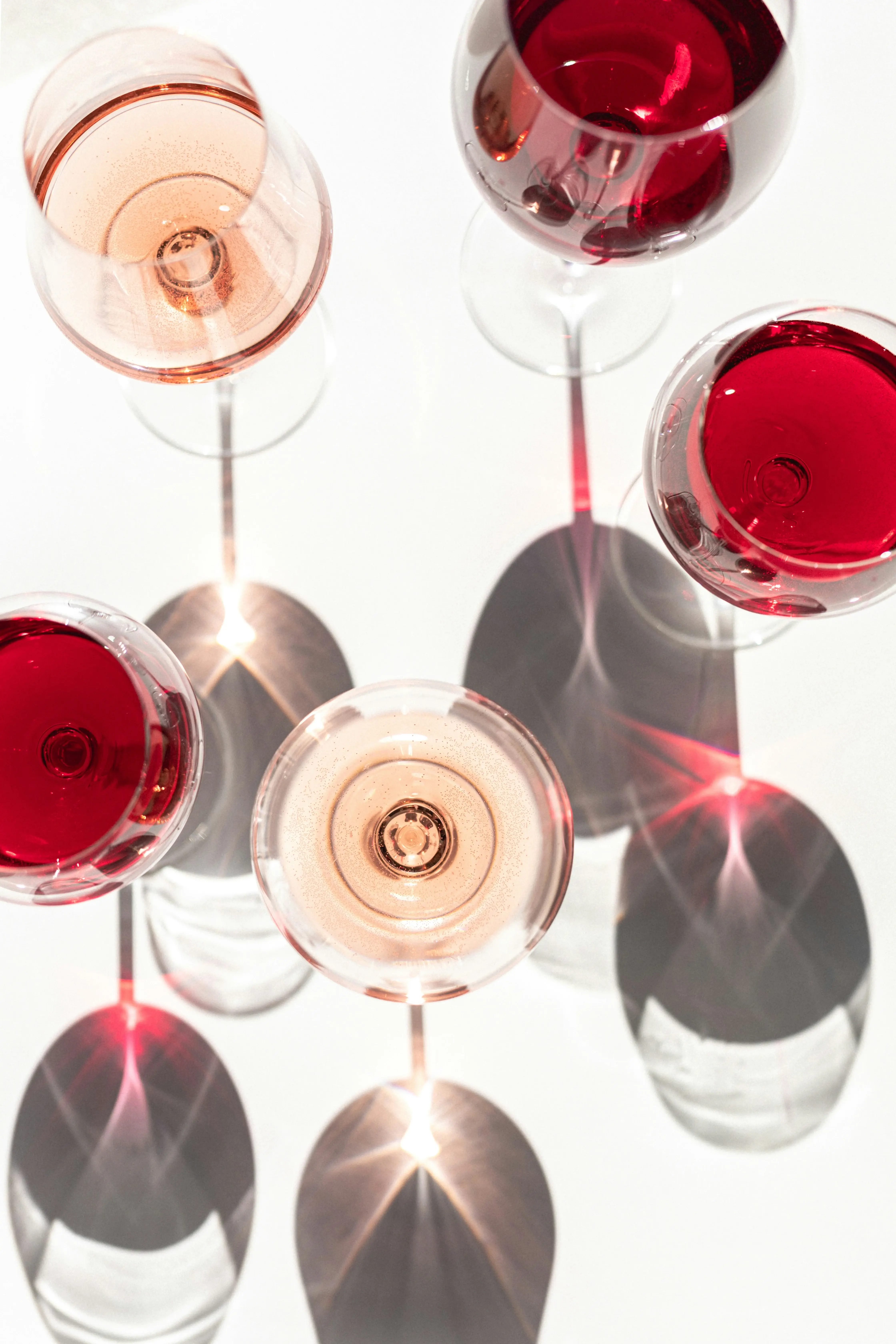 a group of wine glasses with red liquid