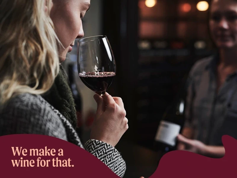 a woman smelling a glass of wine