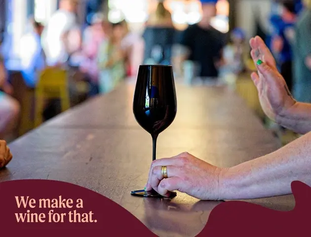 a hand holding a wine glass