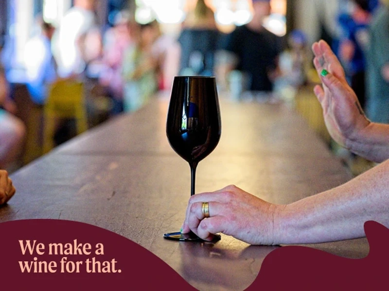 a hand holding a wine glass