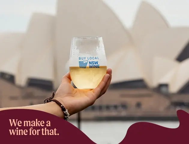 a hand holding a glass of wine