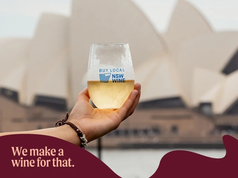 a hand holding a glass of wine