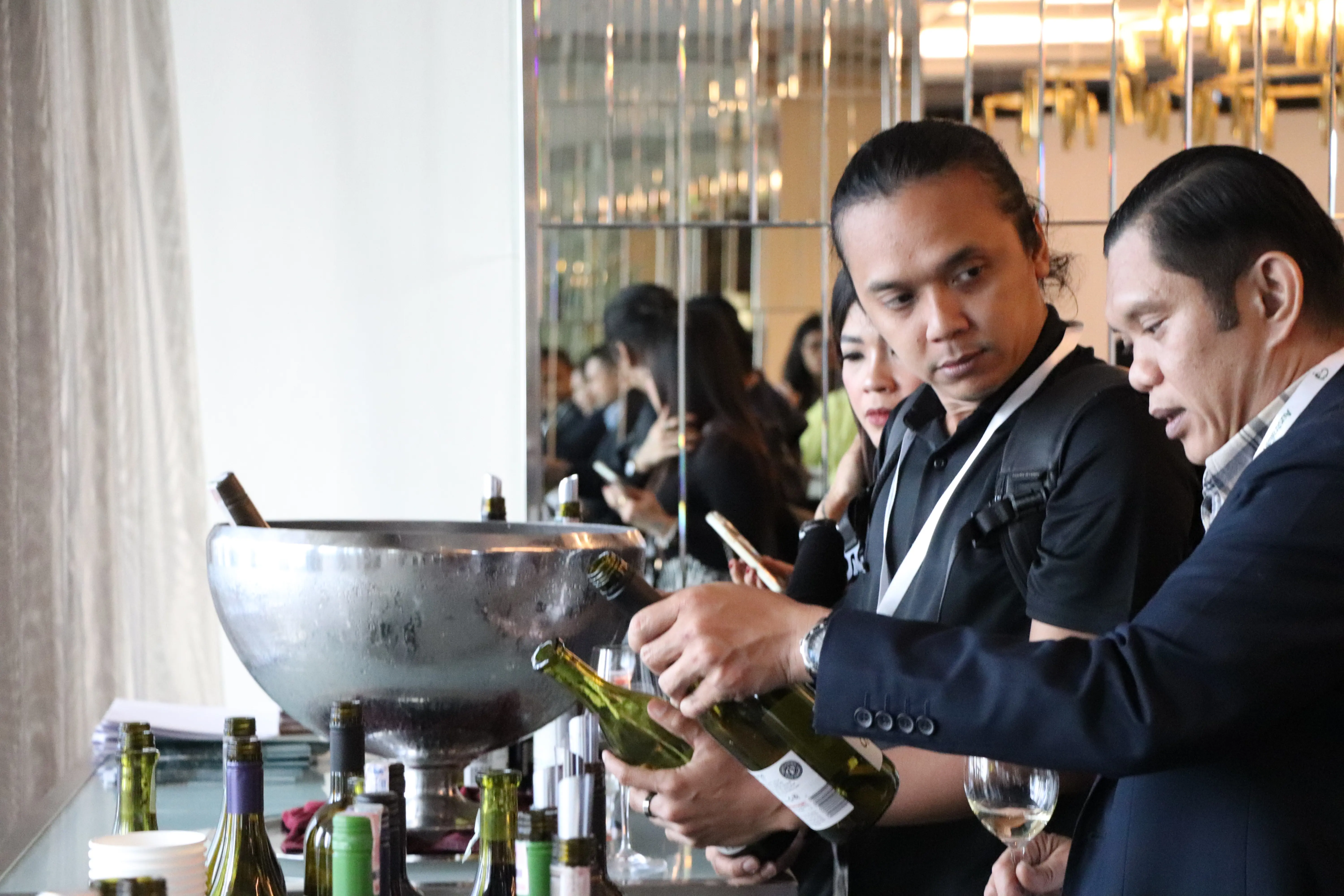a man pouring wine into a bowl
