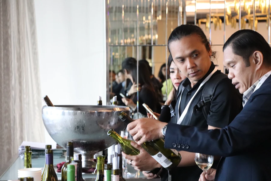 a man pouring wine into a bowl